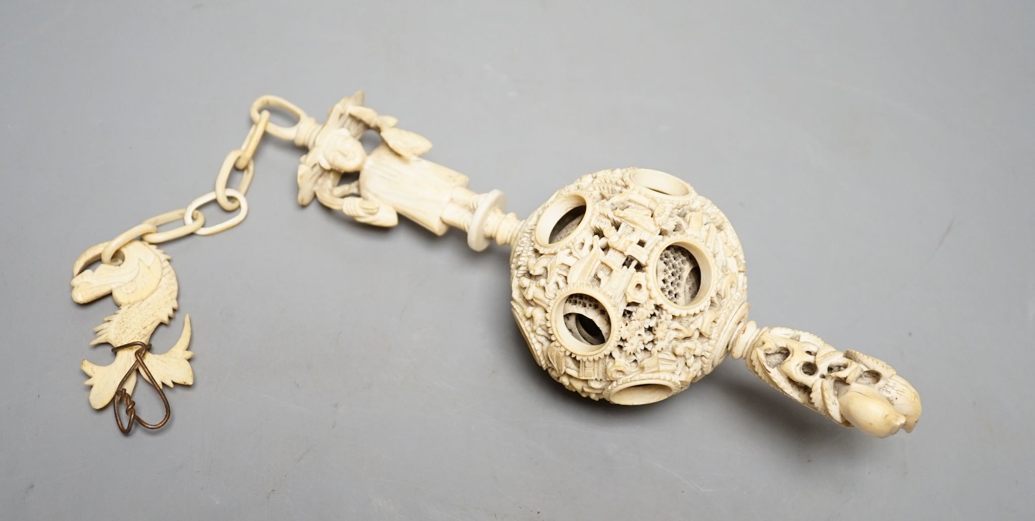A 19th century Chinese export ivory puzzle ball., 31 cms long including chain.